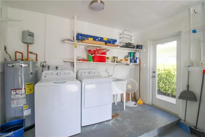 Washroom featuring washing machine and dryer and electric water heater