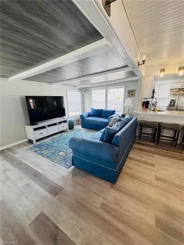 Wood-finish flooring throughout, complemented by a white panel ceiling and recessed lighting
