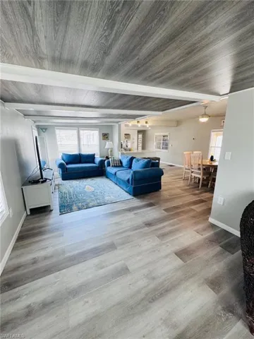 Open concept living space featuring wood-finish flooring, a wood-finish ceiling, and recessed lighting