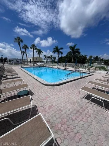 Rectangular swimming pool with integrated steps, surrounded by a paver deck