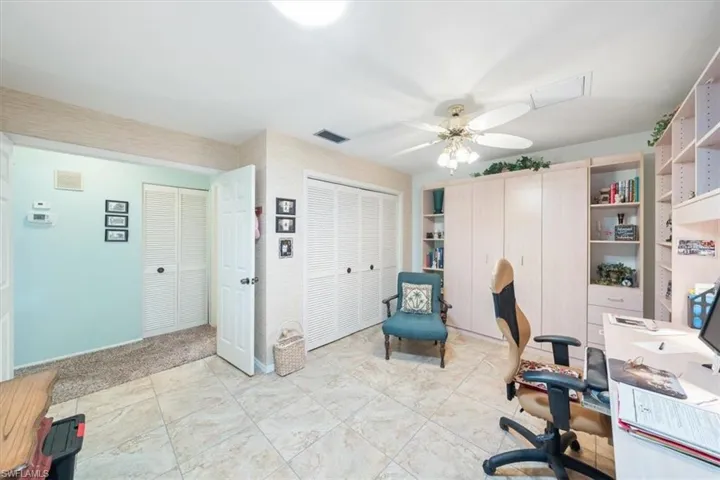 Office space with light tile patterned flooring and ceiling fan