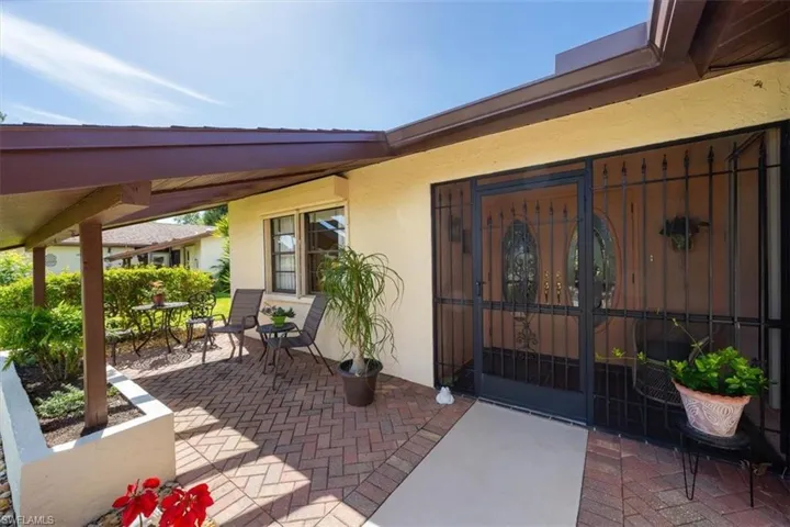 View of exterior entry with a patio area