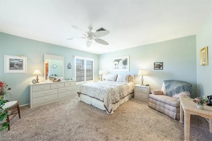 Bedroom featuring ceiling fan and light colored carpet