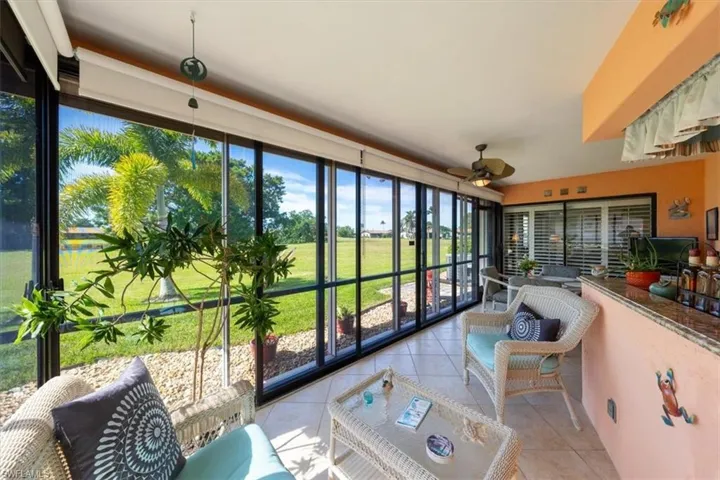 Sunroom / solarium featuring ceiling fan