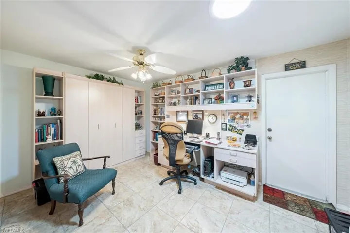 Tiled office space featuring ceiling fan