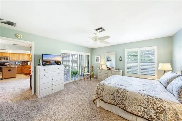 Bedroom featuring light carpet and ceiling fan