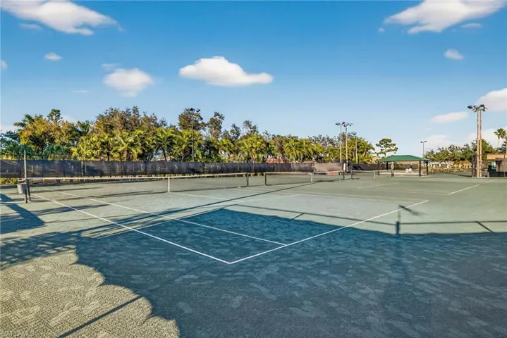 View of tennis court with community basketball court