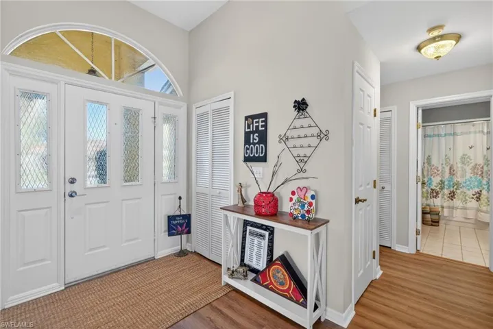Foyer with light wood finished floors and baseboards