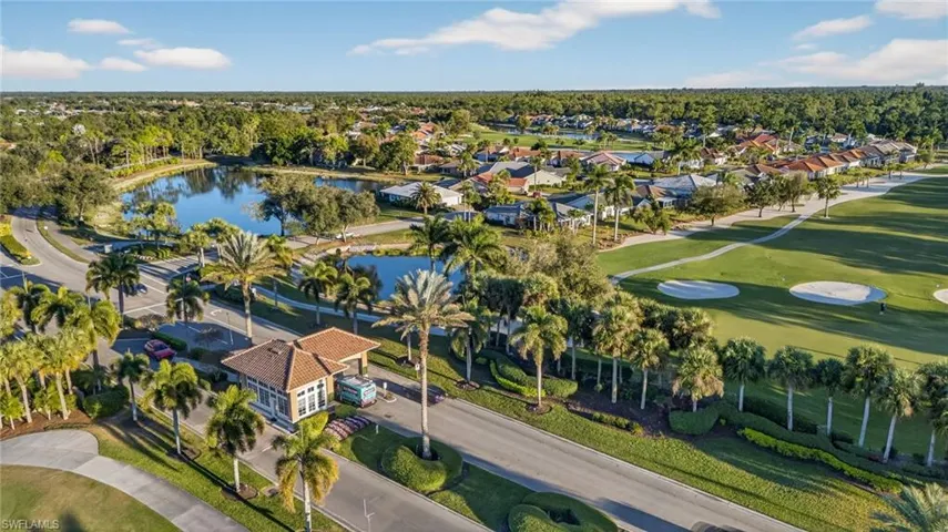 Aerial view of residential area with a large body of water and a golf course
