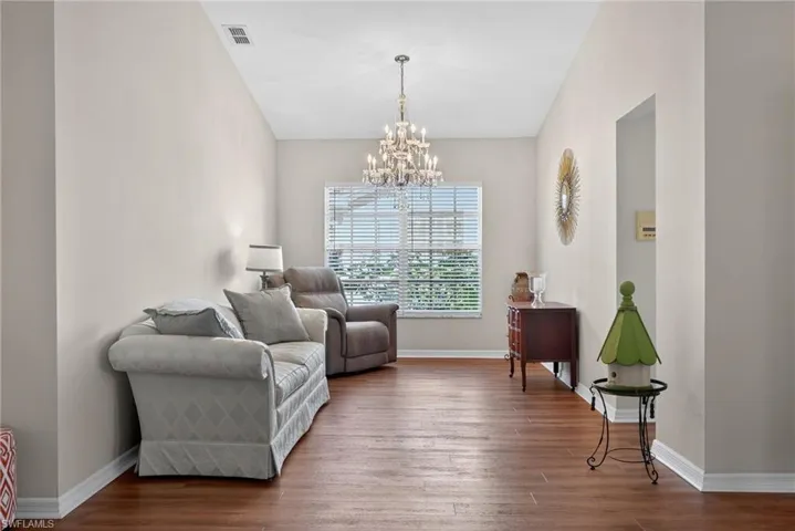 Sitting room featuring wood finished floors and a chandelier