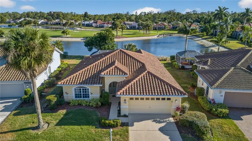 Aerial view of residential area featuring a large body of water