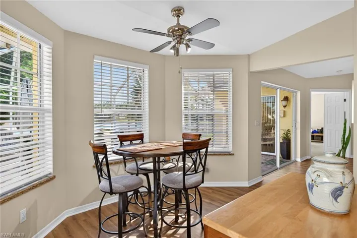 Dining room with wood finished floors and a ceiling fan