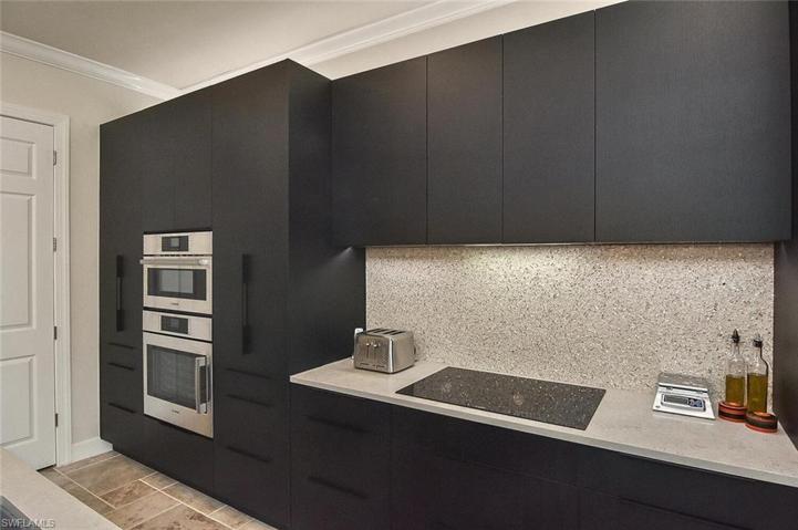 Back splash of recycled glass and mother of pearl.  A beautiful focal point.  INDUCTION COOK TOP with invisible VENT HOOD that vents outside.