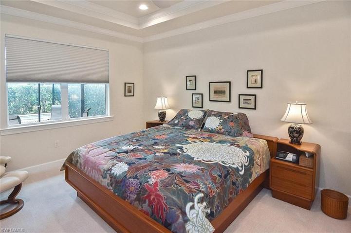 The large Primary Bedroom with double windows and tray ceiling.