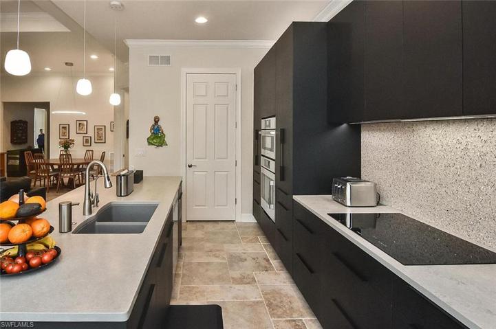 Custom European Kitchen with White Oak cabinetry with Volcanic Stone finish. Large INDUCTION COOK TOP with invisible VENT HOOD that vents outside.