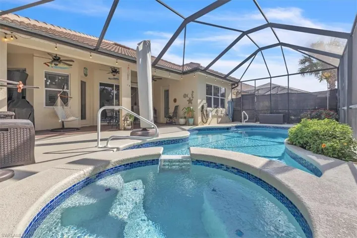 Combined pool / hot tub with a sunroom, a patio, and a lanai