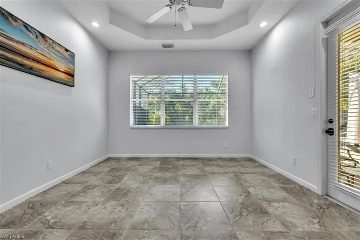 Spare room featuring ceiling fan, recessed lighting, and a tray ceiling