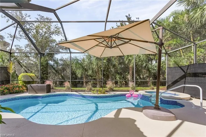 Integrated pool / spa featuring a lanai, a sunroom, and a patio area