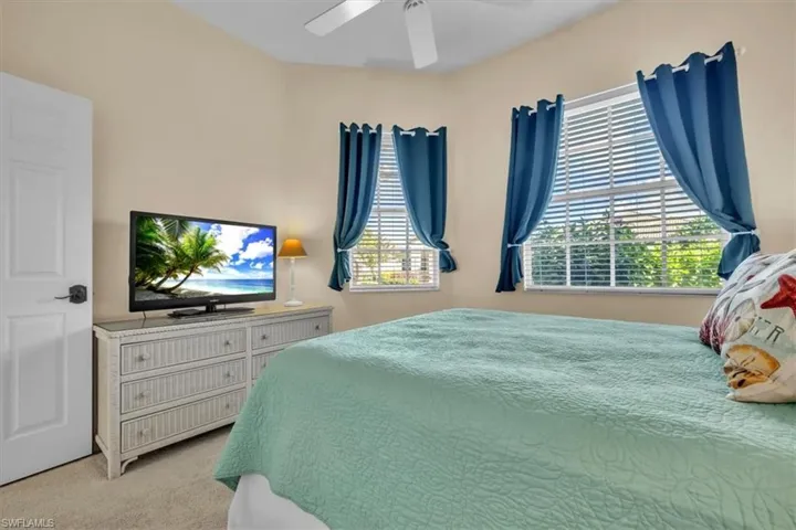 Bedroom featuring light colored carpet and ceiling fan