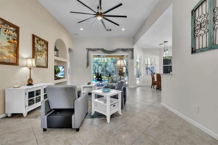 Living area featuring ceiling fan, light tile patterned floors, and recessed lighting