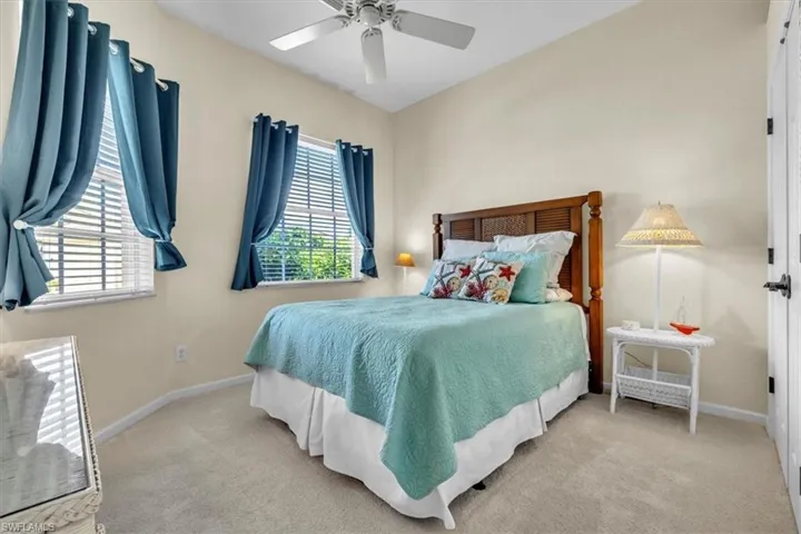 Bedroom featuring light carpet and a ceiling fan