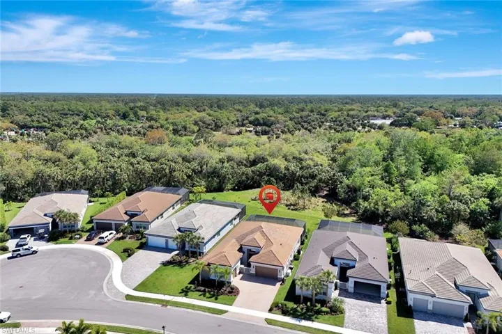 Aerial view with a wooded view and a residential view