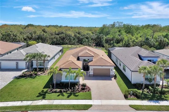 Birds eye view of property with a forest view