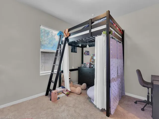 Carpeted bedroom featuring baseboards