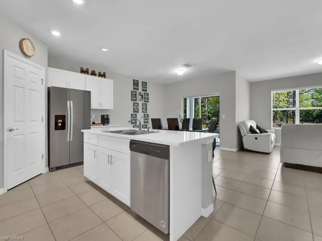 Kitchen featuring a wealth of natural light, open floor plan, appliances with stainless steel finishes, and a sink