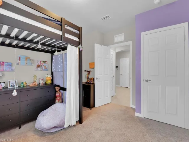 Bedroom featuring visible vents, baseboards, and carpet floors