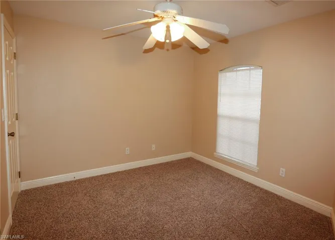 Neutral-toned walls complement plush brown carpeting