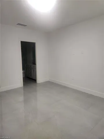 Empty room featuring baseboards and light marble finish flooring