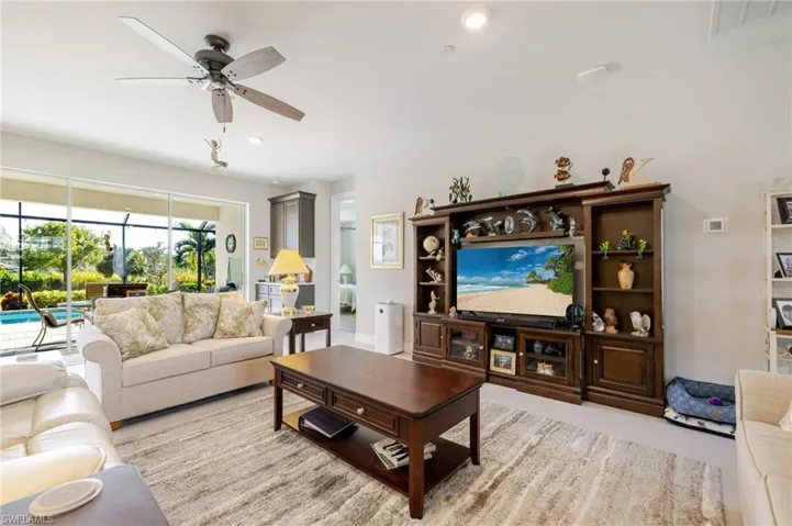 Living room featuring ceiling fan and recessed lighting