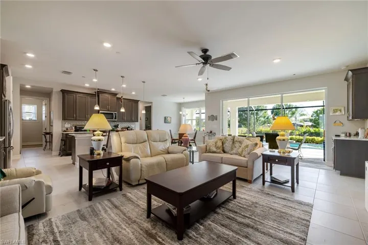 Living room with recessed lighting, ceiling fan, and light tile patterned floors