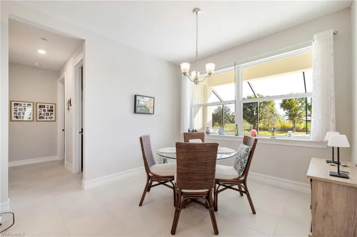 Dining area featuring a chandelier and light tile patterned flooring