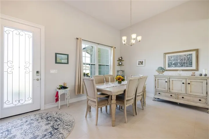 Dining area with baseboards and a chandelier