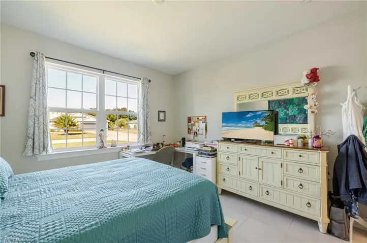 Bedroom with light tile patterned floors