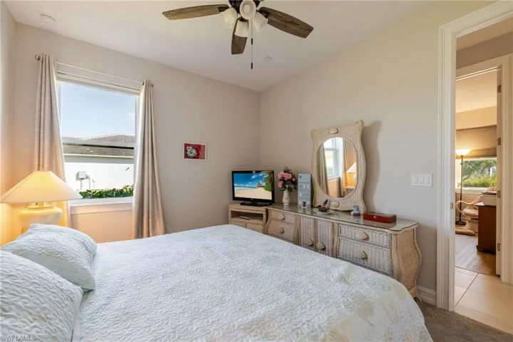 Bedroom with multiple windows and ceiling fan