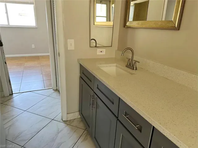 Bathroom with vanity and healthy amount of natural light