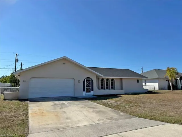 Ranch-style house with stucco siding, concrete driveway, and an attached garage
