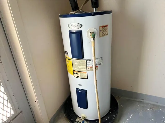 Utility room featuring electric water heater