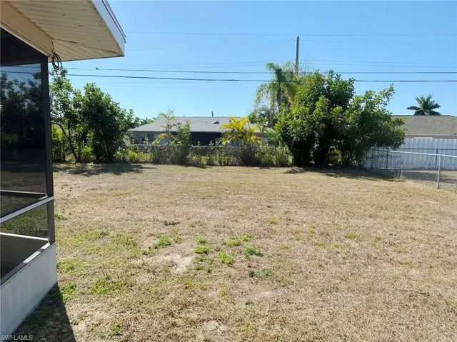 Fenced backyard with a sunroom