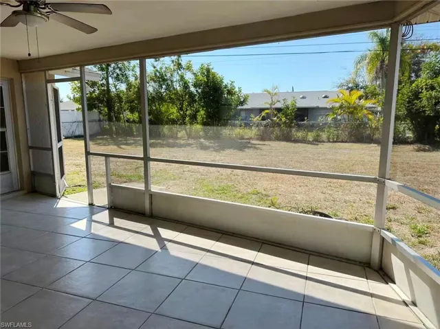 Unfurnished sunroom with ceiling fan