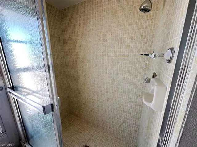 Full bathroom with a shower stall