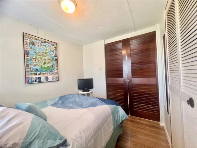Bedroom featuring light hardwood / wood-style flooring and a textured ceiling