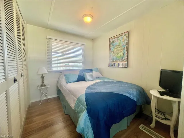 Bedroom with hardwood / wood-style flooring