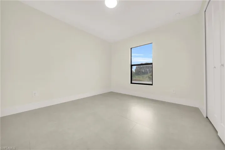 Unfurnished bedroom featuring a closet and baseboards