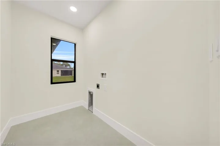 Washroom featuring hookup for an electric dryer, washer hookup, concrete floors, and recessed lighting