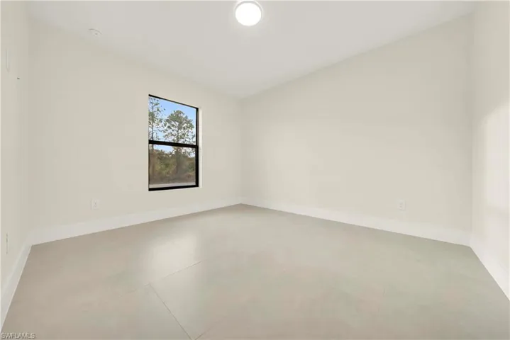 Unfurnished room featuring baseboards