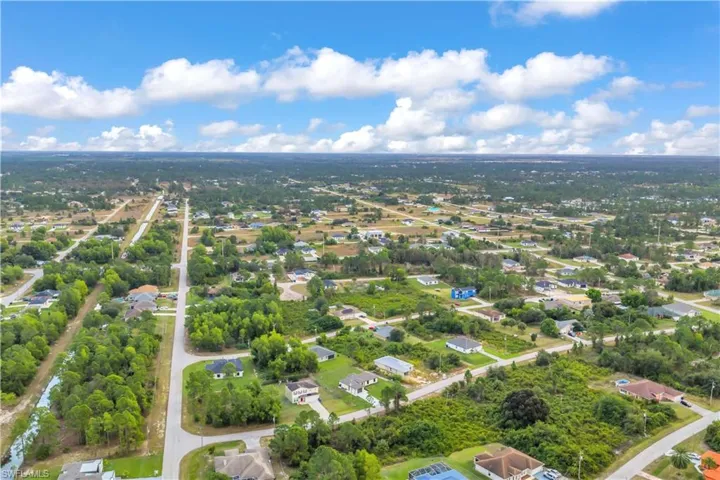 Aerial view of residential area featuring a tree filled landscape